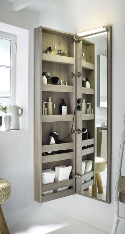 Mirrored cabinet with shelves for dual-purpose bathroom storage ideas and small bathroom solutions.